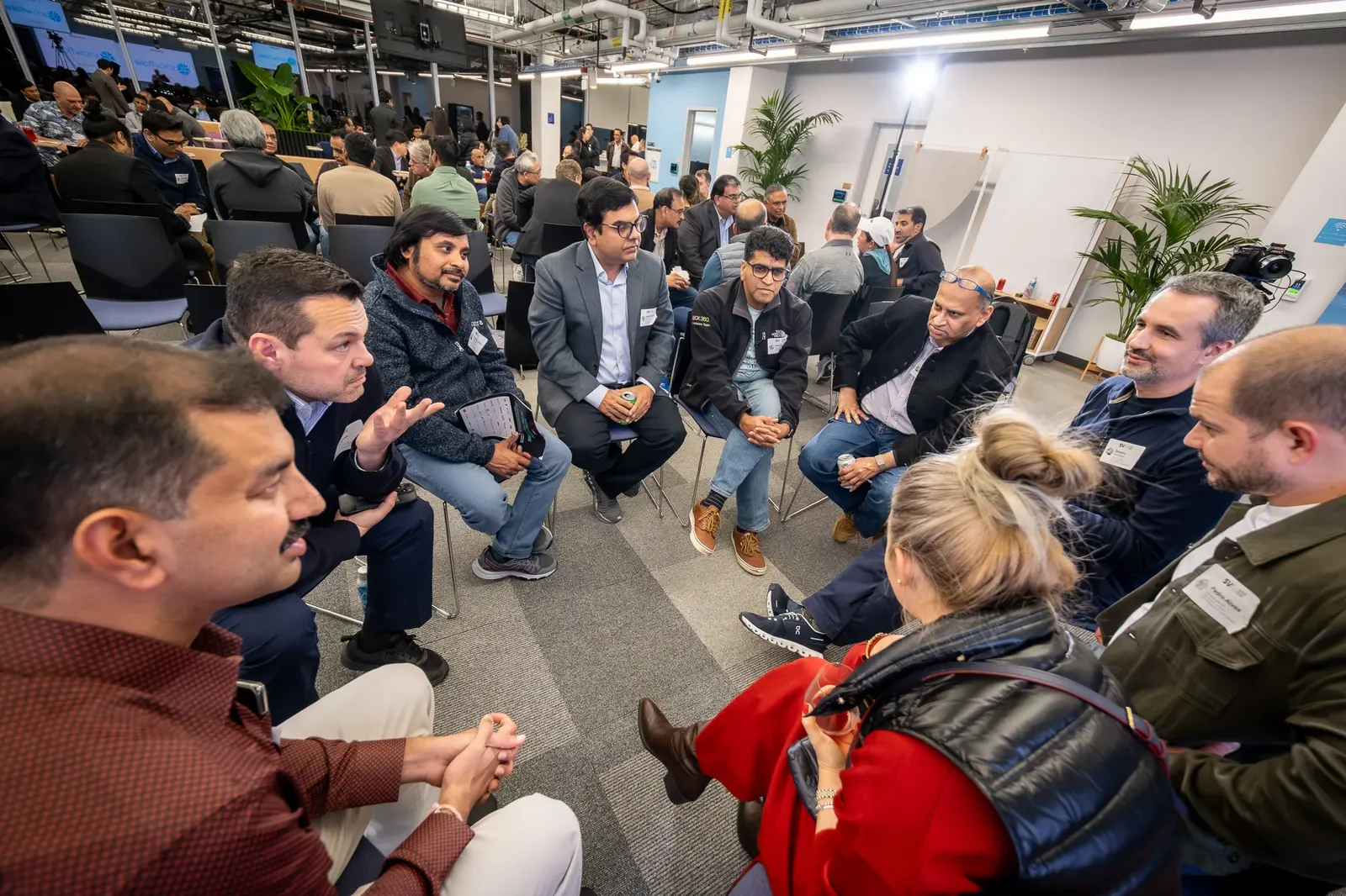 Conference participants seated in a circle for a discussion