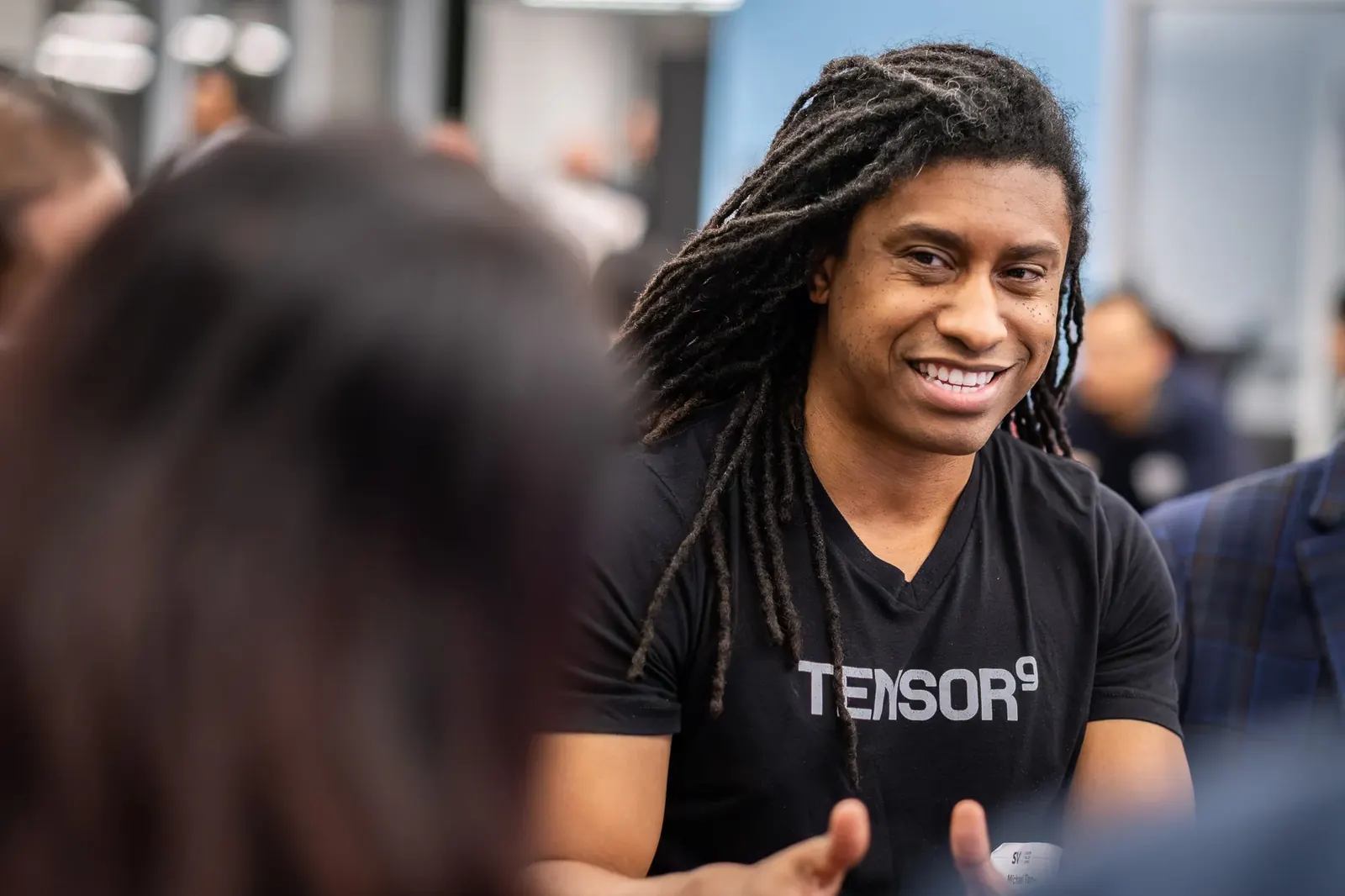 Smiling participant in conversation at an event
