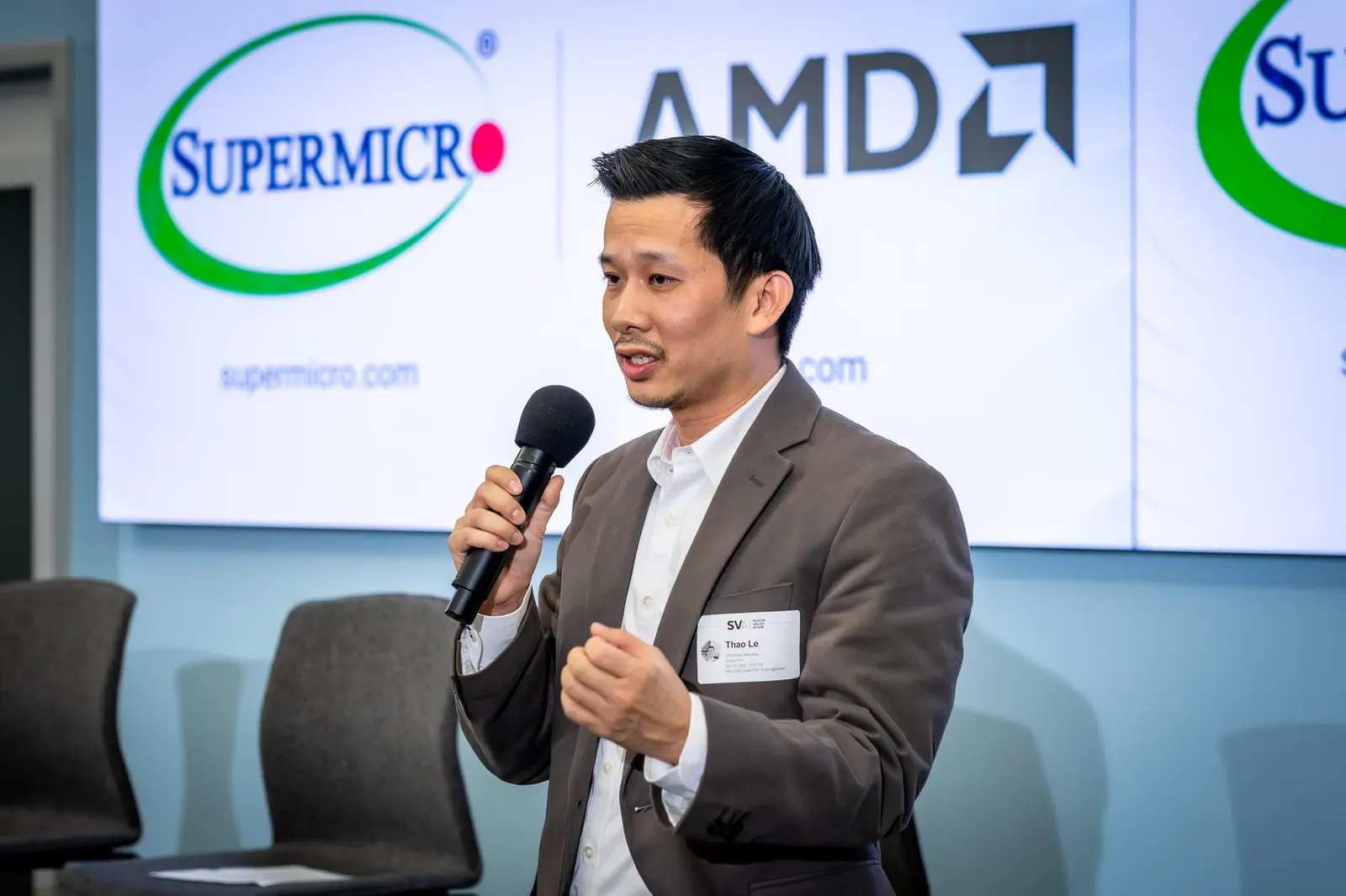 Speaker in front of a technology presentation screen