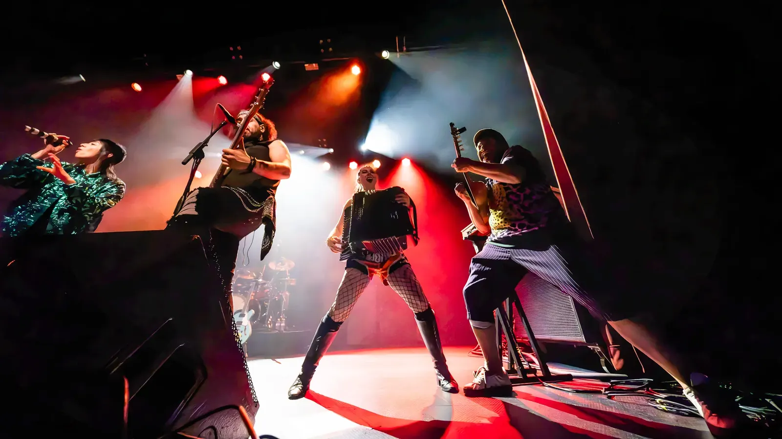 Musicians performing at the front of the stage
