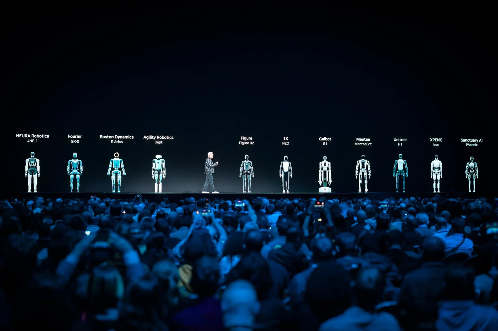 NVIDIA keynote stage with a panoramic display of humanoid robots and a blue-lit audience