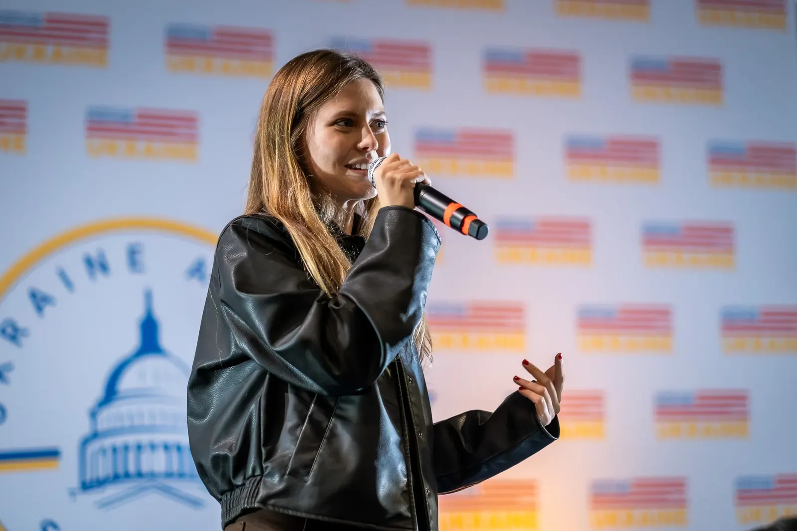 Speaker holding a microphone at Ukraine Action Summit